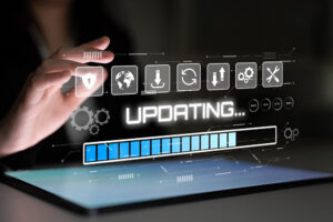 Hand hovering over laptop waiting to upgrade.