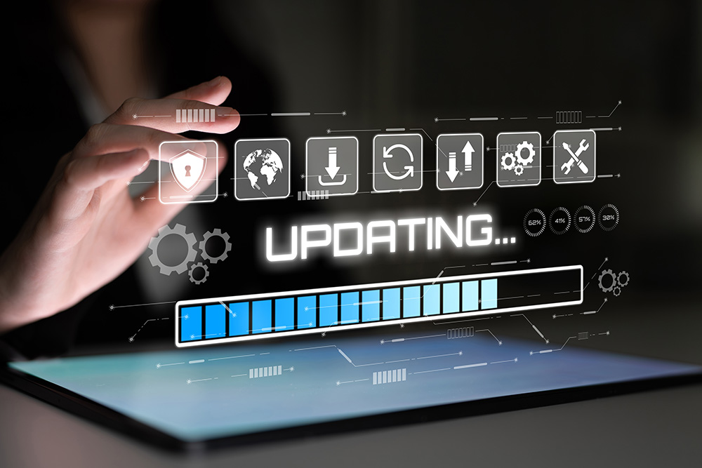 Hand hovering over laptop waiting to upgrade.